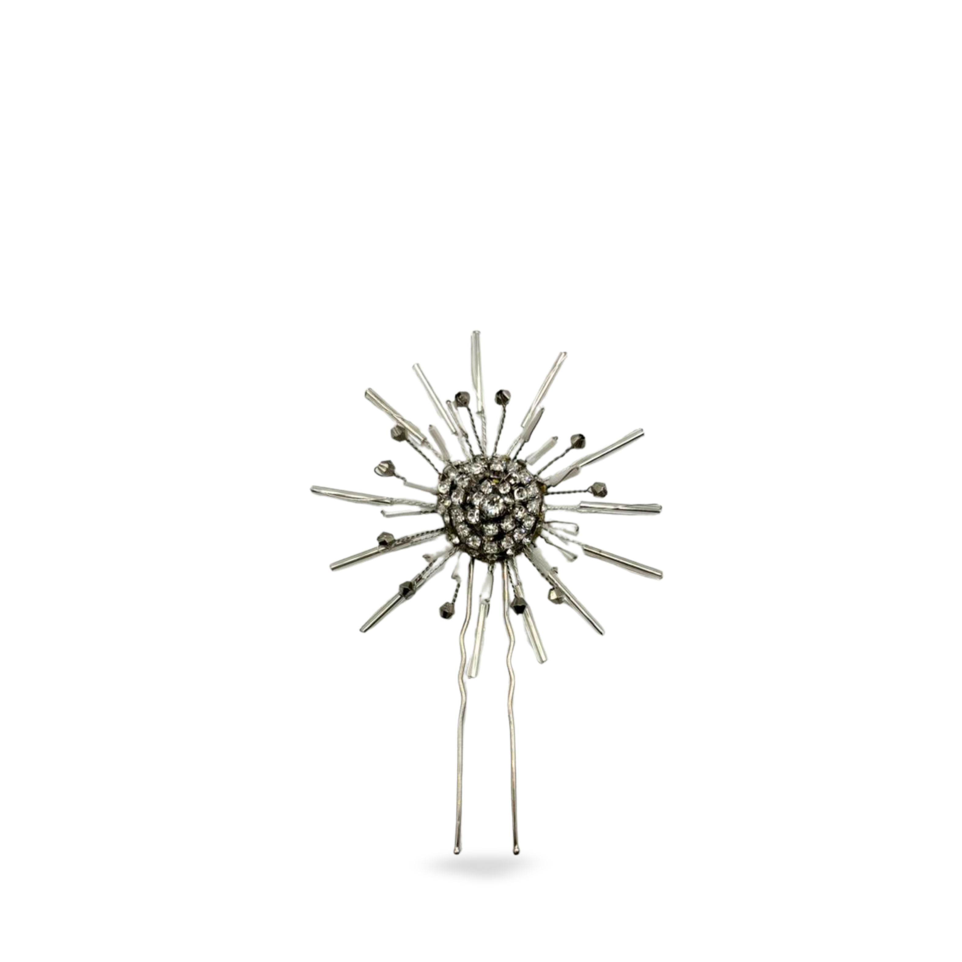 Stylish sunburst hair pin with central gemstones on a white background